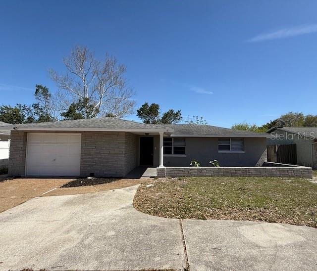 ranch-style home featuring a garage and driveway