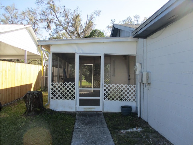 entrance to property featuring fence