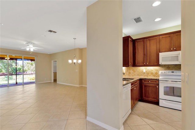 kitchen with tasteful backsplash, white appliances, visible vents, and light tile patterned flooring