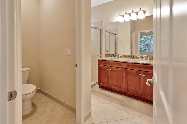 full bathroom with double vanity, toilet, a stall shower, a sink, and tile patterned floors