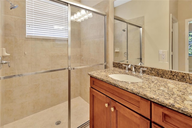 full bathroom with a stall shower and vanity