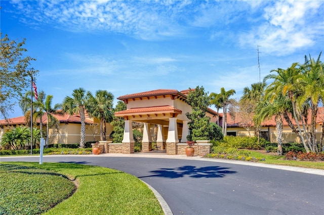 view of front of house featuring stone siding, a tile roof, and stucco siding