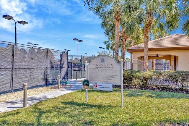 view of home's community with a yard, fence, and a gate