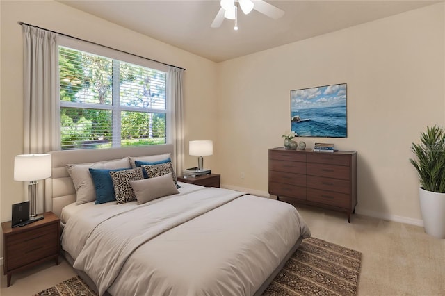 bedroom featuring light carpet, a ceiling fan, and baseboards