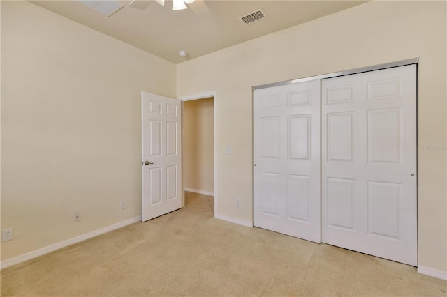 unfurnished bedroom featuring a closet, visible vents, a ceiling fan, light carpet, and baseboards