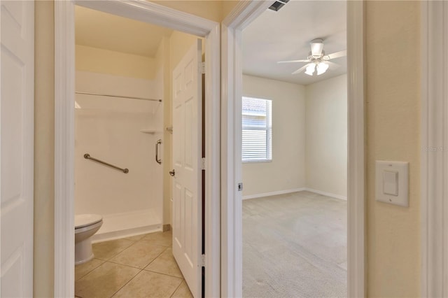 full bath featuring visible vents, a ceiling fan, toilet, tile patterned floors, and a shower stall