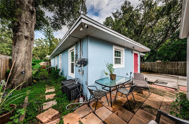 exterior space with outdoor dining area and fence