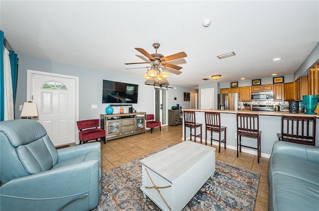 living room with light tile patterned floors, a ceiling fan, and recessed lighting