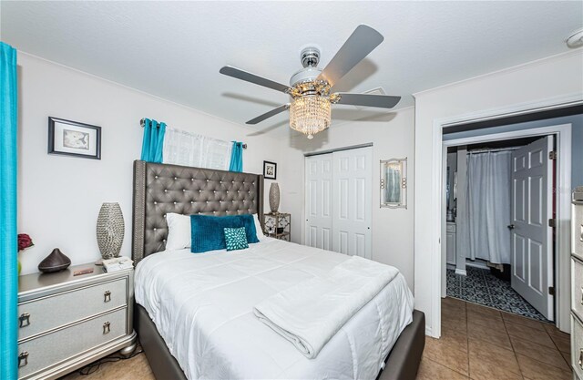 bedroom with tile patterned flooring, a closet, and a ceiling fan