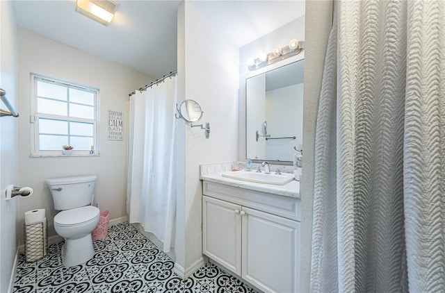 full bathroom featuring tile patterned floors, baseboards, toilet, and vanity