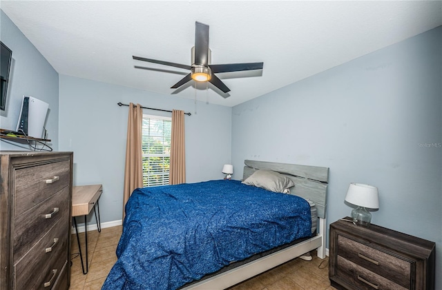 bedroom with light tile patterned floors, baseboards, and ceiling fan