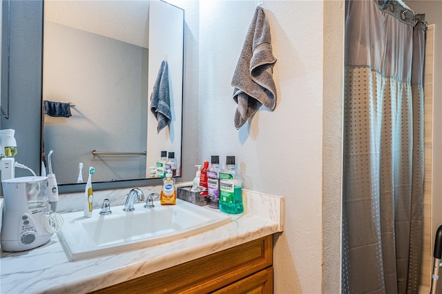 full bath with vanity and a shower with shower curtain