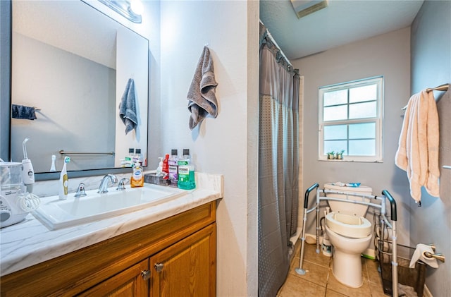 bathroom featuring tile patterned flooring, toilet, and vanity