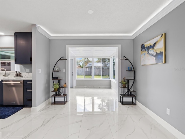 entrance foyer featuring marble finish floor, baseboards, and ornamental molding