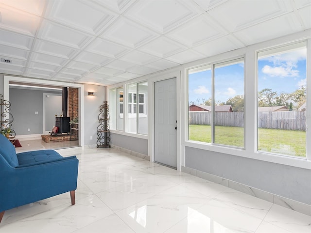 sunroom featuring a wood stove