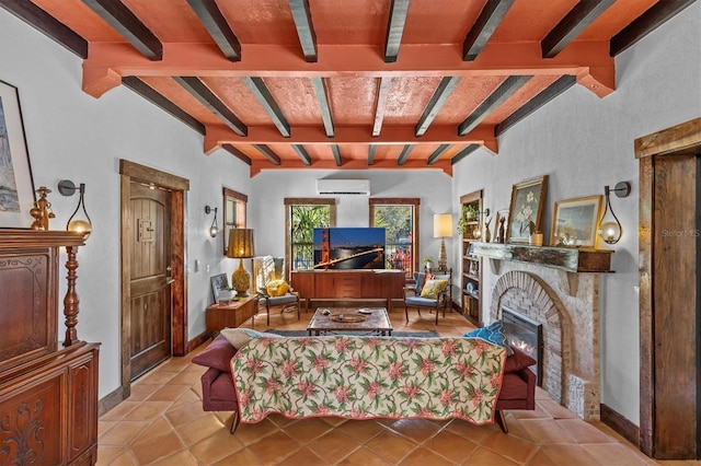 living area featuring a warm lit fireplace, tile patterned flooring, baseboards, an AC wall unit, and beamed ceiling