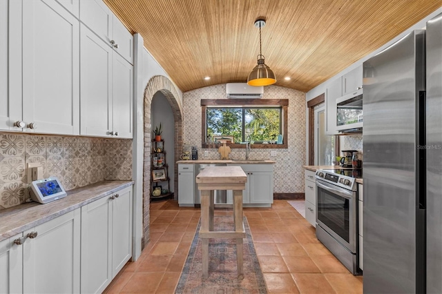 kitchen with wallpapered walls, lofted ceiling, wood ceiling, appliances with stainless steel finishes, and a sink