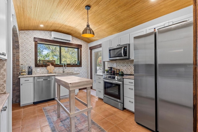 kitchen with a wall unit AC, stainless steel appliances, lofted ceiling, light countertops, and a sink