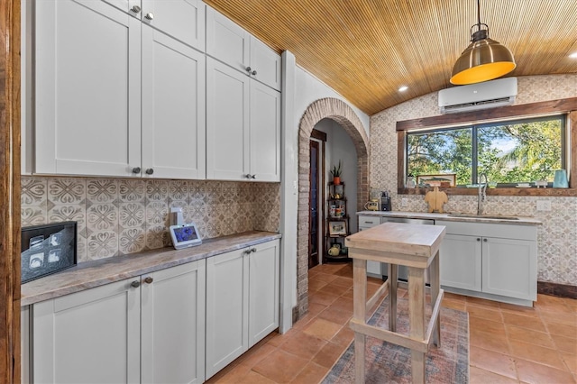 kitchen featuring decorative backsplash, a sink, wooden ceiling, a wall mounted air conditioner, and dishwashing machine