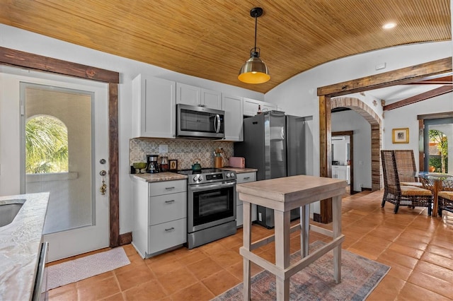 kitchen with arched walkways, lofted ceiling, wooden ceiling, stainless steel appliances, and decorative backsplash