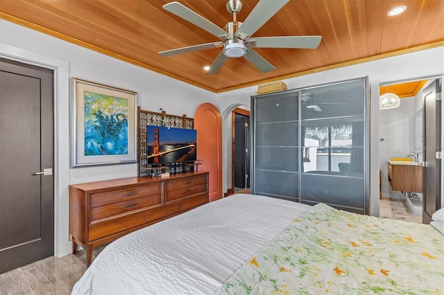 bedroom with arched walkways, ceiling fan, wood ceiling, and crown molding