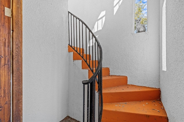 stairway with a textured wall