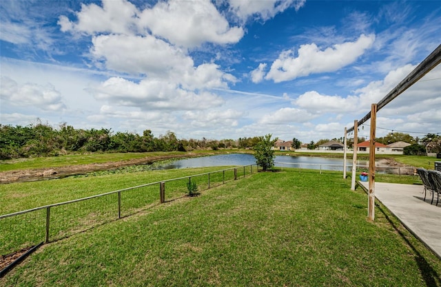 view of yard featuring a water view and fence