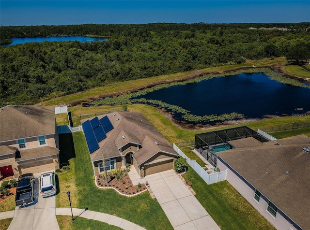 drone / aerial view featuring a view of trees and a water view