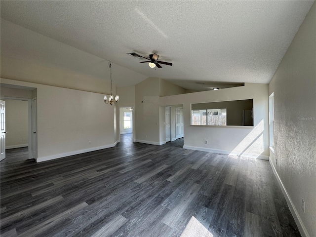 unfurnished living room with lofted ceiling, dark wood-type flooring, a textured ceiling, baseboards, and ceiling fan with notable chandelier