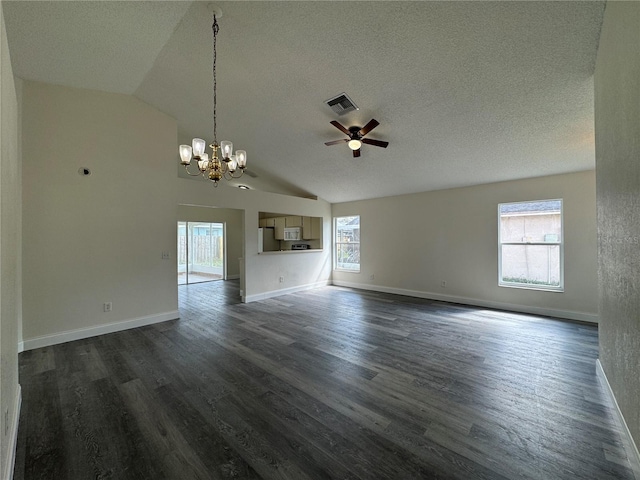 unfurnished living room featuring dark wood-style flooring, visible vents, plenty of natural light, and a textured ceiling