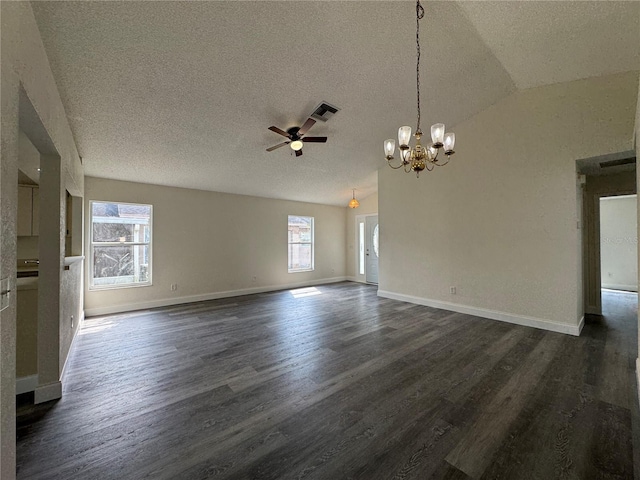 unfurnished living room featuring lofted ceiling, visible vents, dark wood finished floors, and ceiling fan with notable chandelier