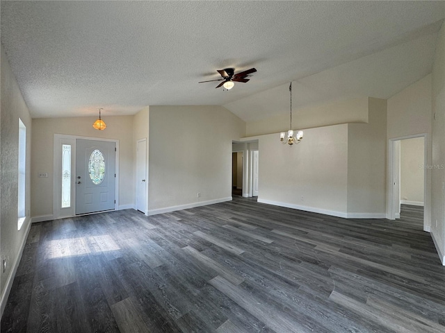 entryway with vaulted ceiling, a textured ceiling, dark wood finished floors, and baseboards