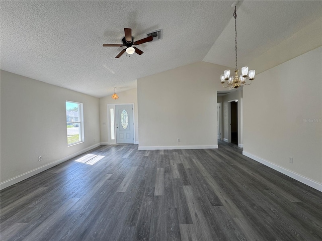 unfurnished living room with baseboards, visible vents, dark wood-type flooring, vaulted ceiling, and ceiling fan with notable chandelier