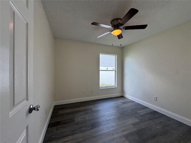 empty room featuring dark wood-style floors, ceiling fan, baseboards, and a textured ceiling