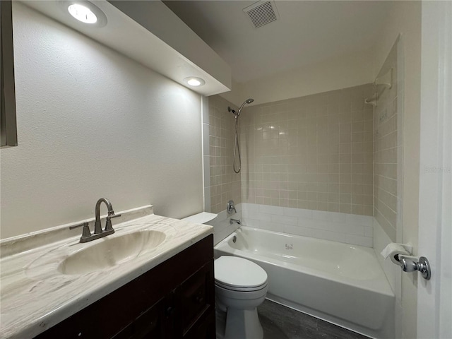 full bath featuring toilet, visible vents, shower / washtub combination, and vanity