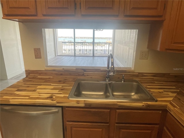 kitchen featuring dishwasher and a sink