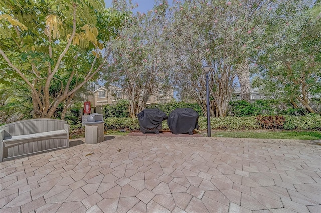 view of patio / terrace featuring a grill and fence