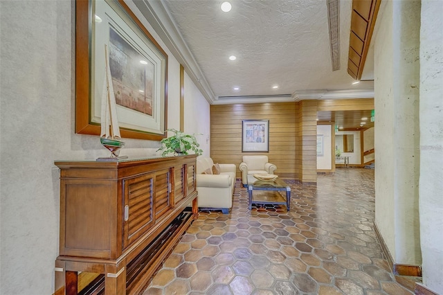 interior space featuring ornamental molding, recessed lighting, and a textured ceiling