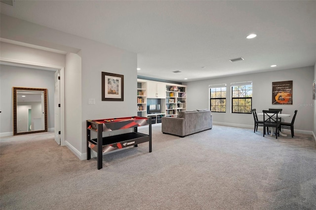 rec room featuring recessed lighting, light carpet, and baseboards