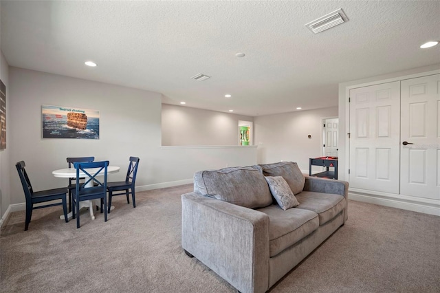 living room featuring recessed lighting, visible vents, light carpet, and baseboards