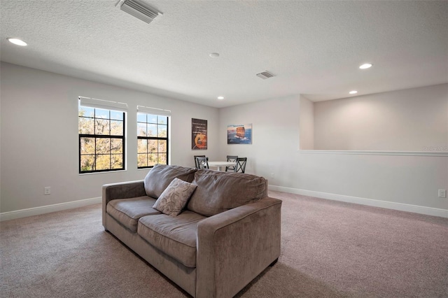 living area featuring carpet, visible vents, baseboards, and recessed lighting