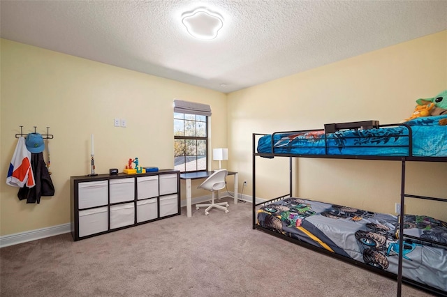 carpeted bedroom with baseboards and a textured ceiling