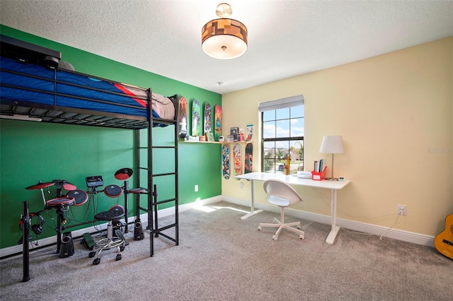 carpeted bedroom featuring a textured ceiling and baseboards