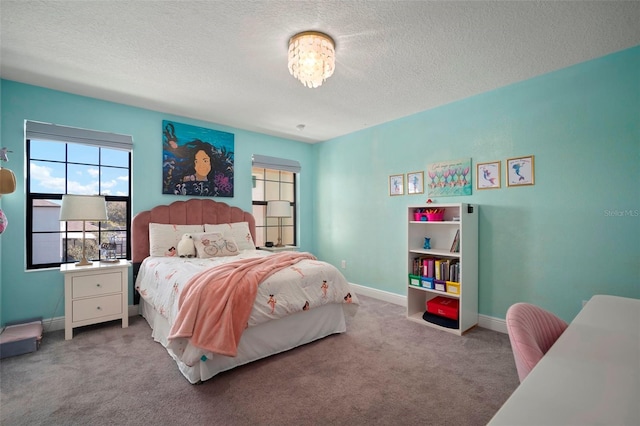 bedroom with carpet floors, baseboards, and a textured ceiling