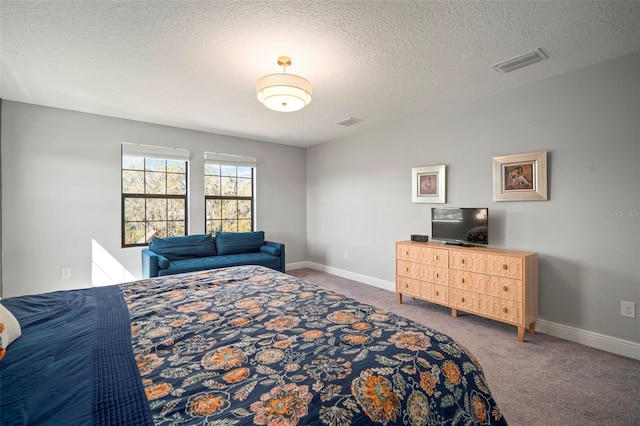 bedroom featuring baseboards, carpet, visible vents, and a textured ceiling