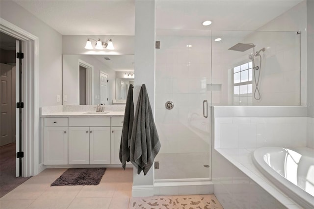 full bathroom with a bath, a shower stall, vanity, and tile patterned floors