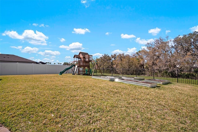 view of jungle gym with a yard and a fenced backyard