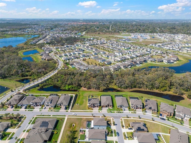 drone / aerial view featuring a residential view and a water view