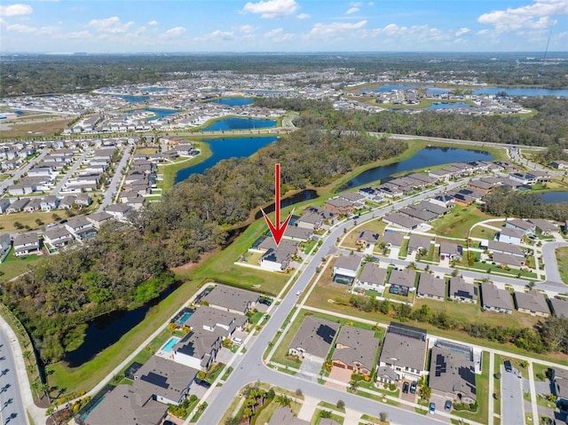 birds eye view of property with a water view and a residential view