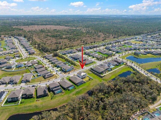 drone / aerial view featuring a water view and a residential view